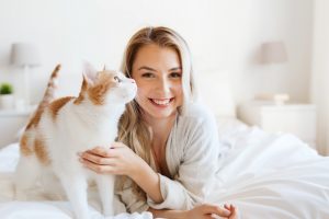 a happy new homeowner with her pet cat